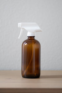 Refillable amber glass spray bottle with white sprayer